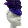 Stunning purple felt base headpiece with irridescent blue embelished detail and finished with stunning hand made silk flower details.